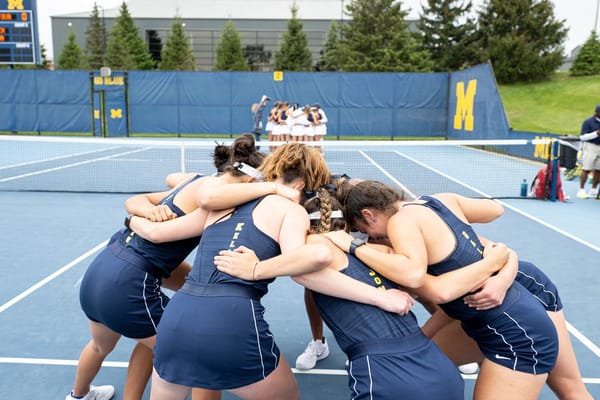 Women's tennis huddles up before their match against Virginia in the 2023 Sweet Sixteen.